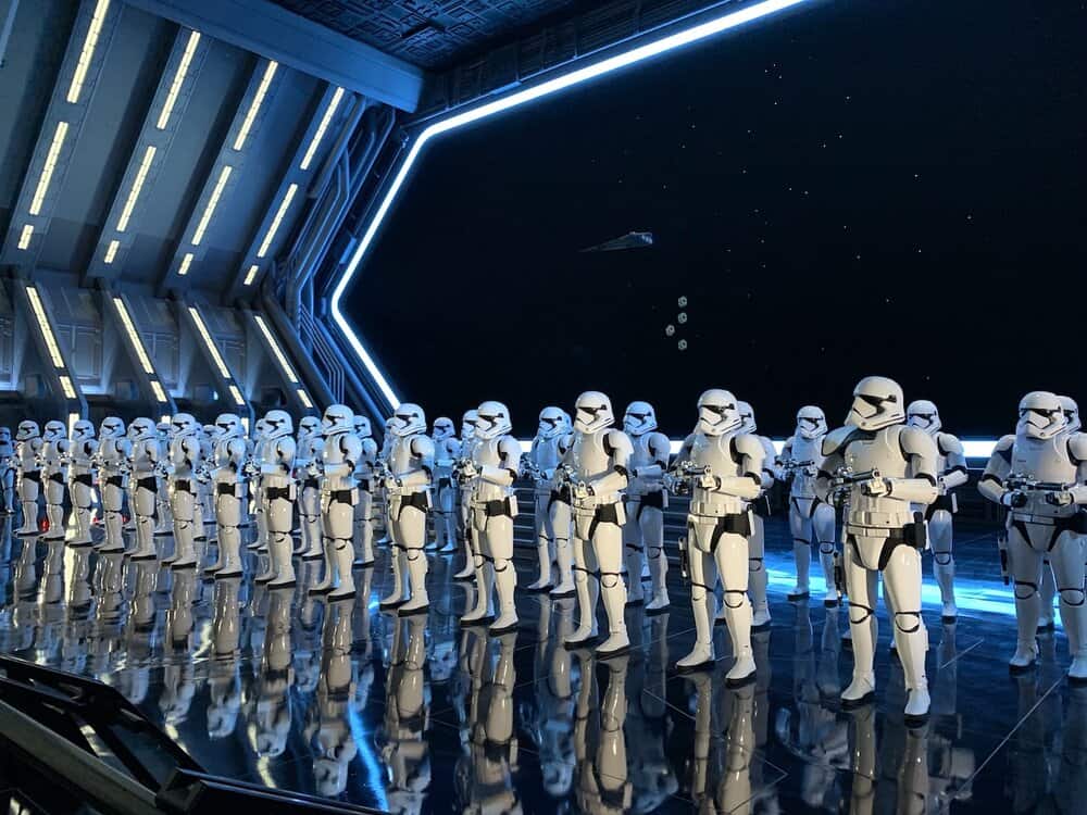 Storm Troopers line up in Disneyland's Rise of the Resistance. They inspire some Star Wars themed Disney jokes.